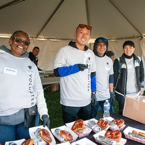 volunteers handing out pretzels and hot dogs volunteers handing out pretzels and hot dogs